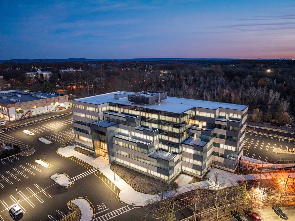 Aerial view of the Thalwei Abstract office building at dusk